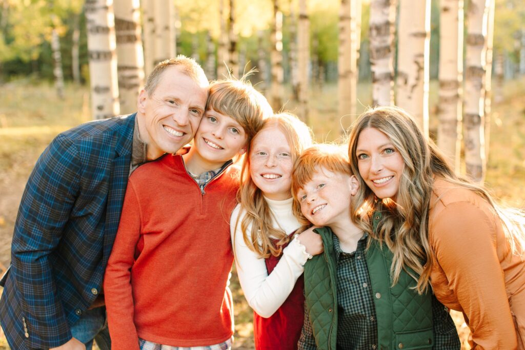 Family in the golden aspens of Flagstaff, Arizona in the fall